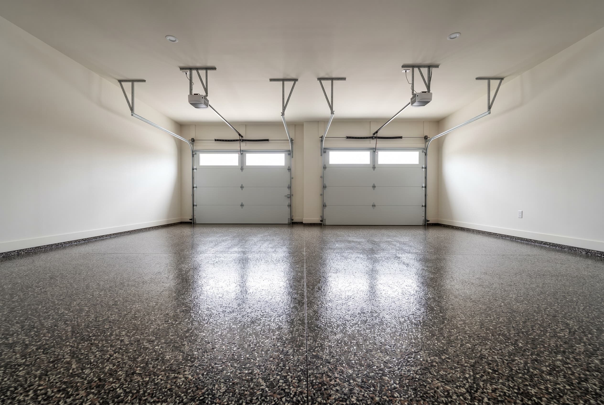 Wide two-car Troy garage with full-broadcast decorative flake epoxy.