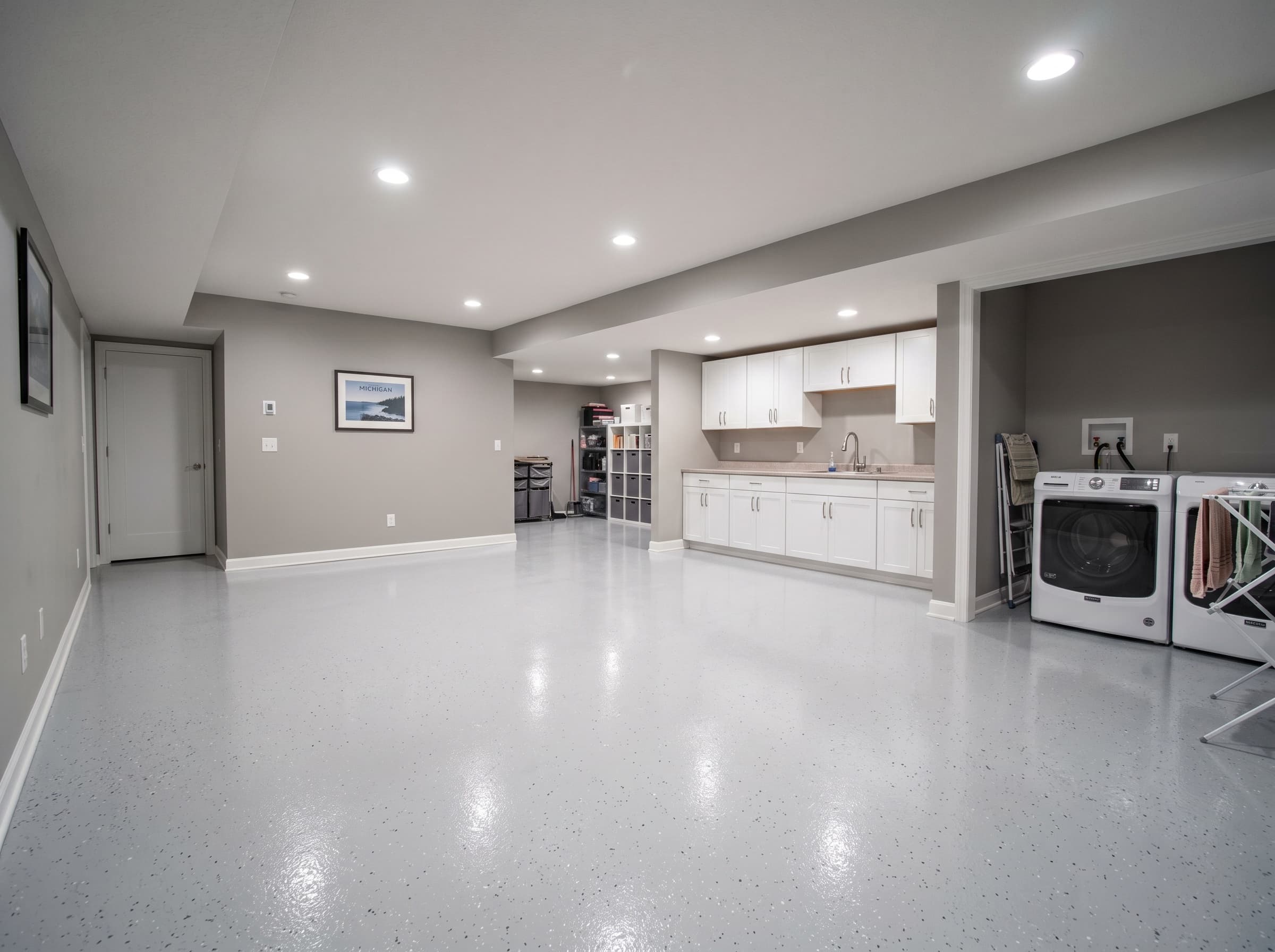 Finished Troy basement with warm grey vinyl-flake epoxy floor.