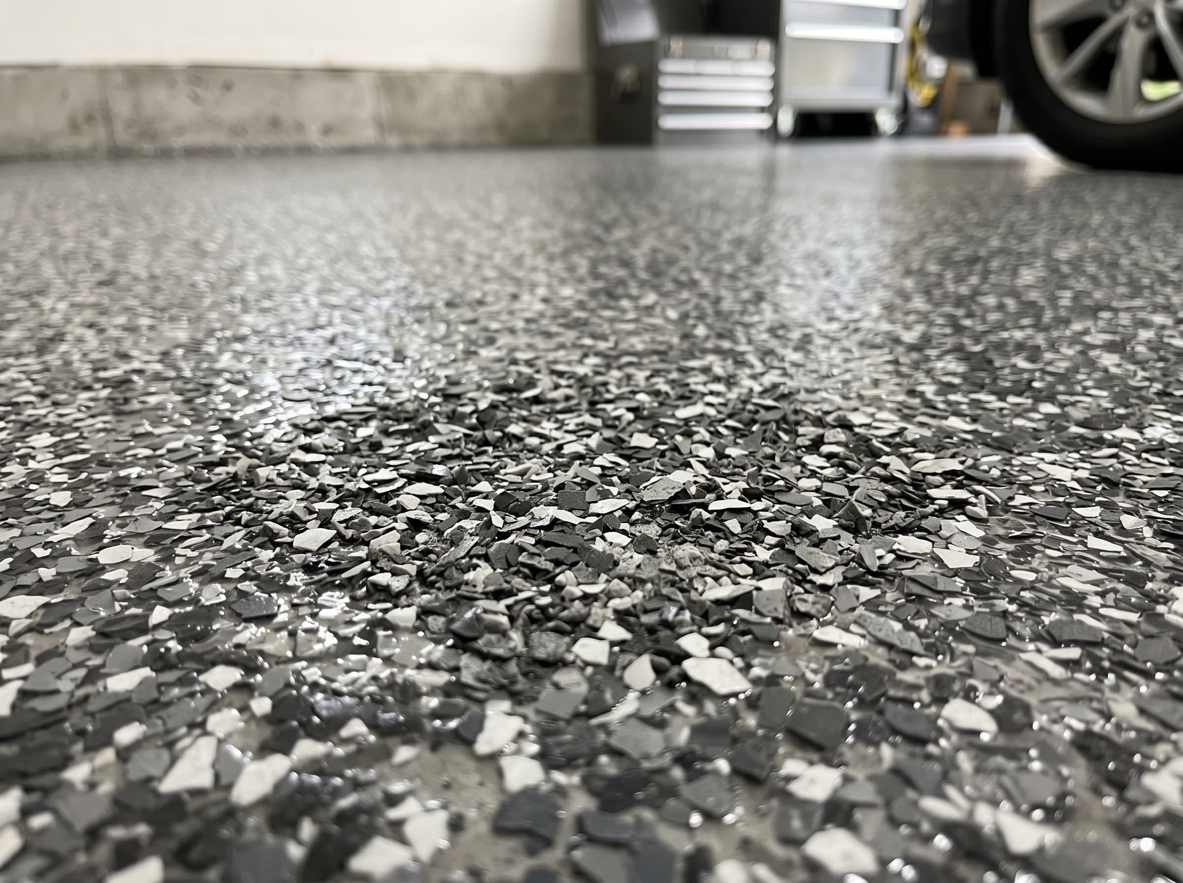 Decorative flake-and-chip epoxy floor finish. Full-broadcast vinyl flake system.