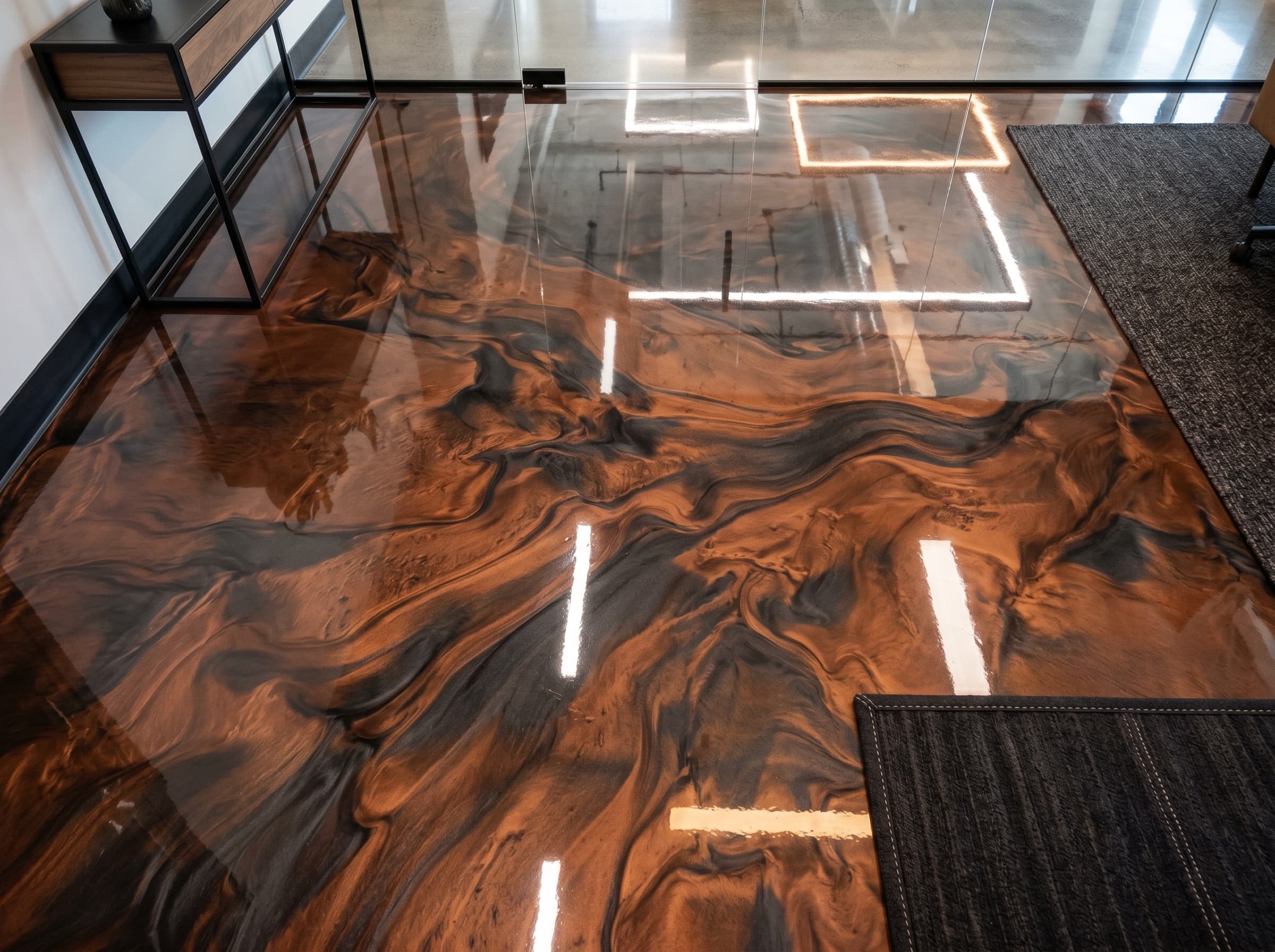 Metallic epoxy flooring in Troy, MI — copper-and-charcoal swirl finish with mirror-grade reflection.