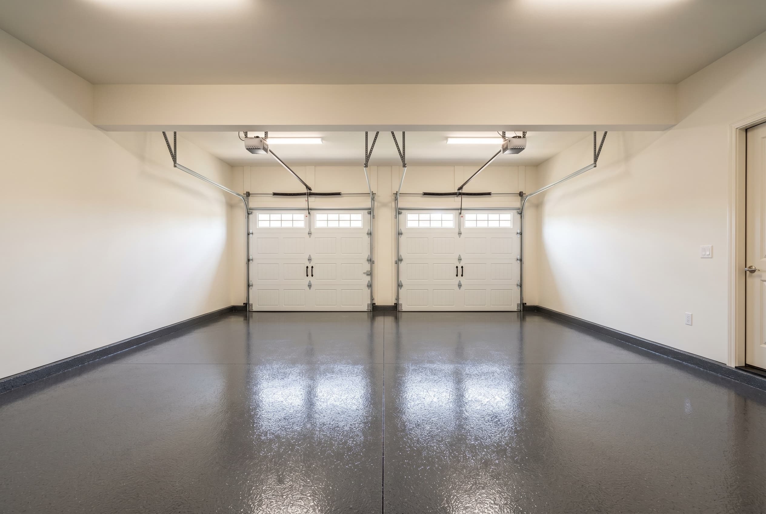 Wide finished Troy garage after recoat, uniform charcoal flake floor.