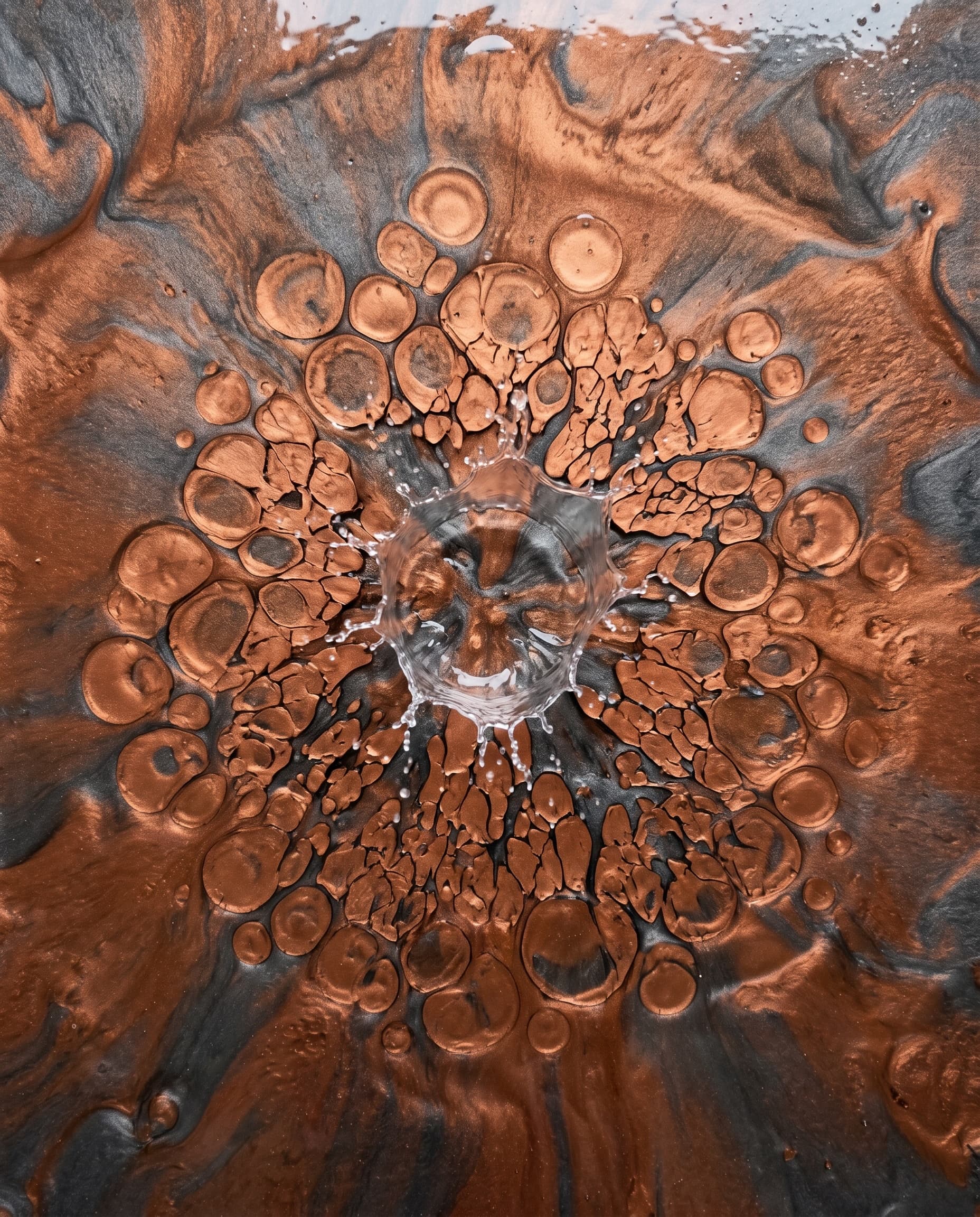 Alcohol pour creating expanding cells in wet metallic epoxy.