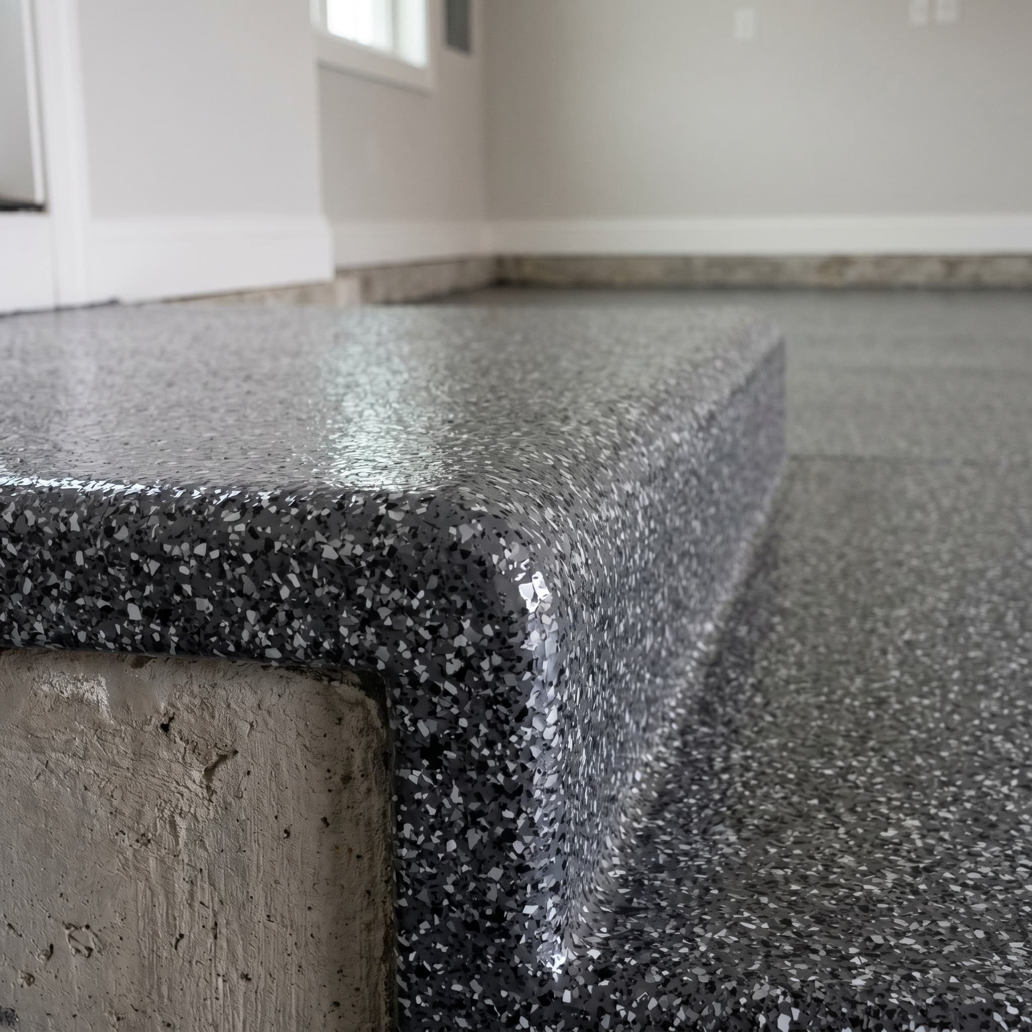 Polyaspartic rolled over a Troy garage step edge profile.